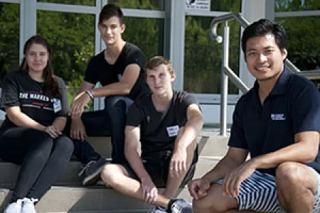 Students embrace science. From left: Crystal Lenegan-Dry, Johannes du Plessis and Noah Hanrahan with PICSE-CDU Science Education Officer John Sagun