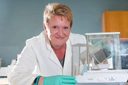 Mrs Sinclair … Examining soil samples for radio-active particles.