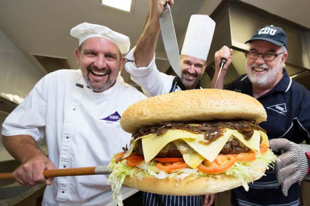 Charles Darwin University VET Culinary Arts lecturers, baker Robert Schwerdt, chef Jason Wilkes, and butcher Rodney Sims practising for Sunday’s attempt to cook the Territory’s biggest burger.