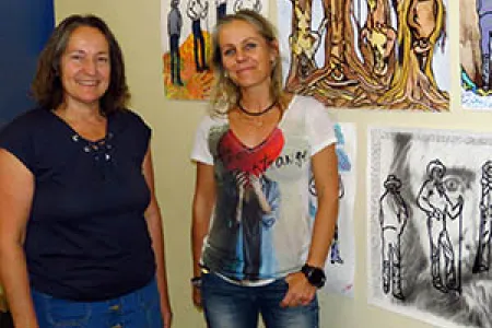 From left: Dr Judith Lovell and Dr Al Strangeways with a sample of the works in their public arts engagement project.