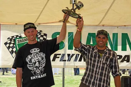 Jared Bentvelzen and Justin Lord hold aloft the Flying Spanners trophy.