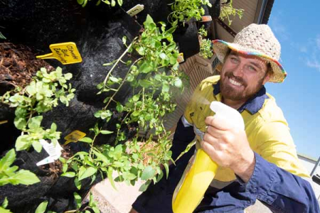 Horticulture student Ben Nicholls with the vertical edible garden