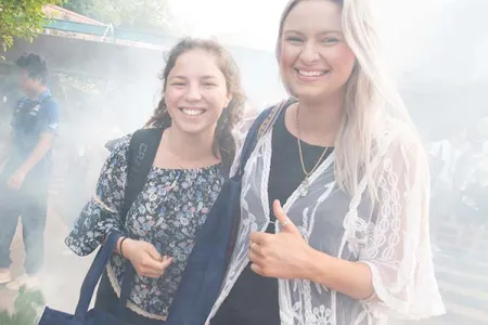 New CDU Psychology students Emmy Lang and Jacquelyn Agustin enjoy a traditional smoking ceremony as part of the university’s Semester 2 Orientation activities