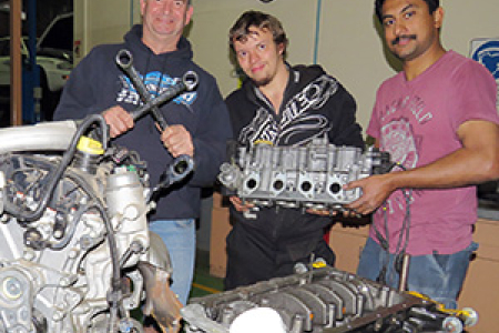 Automotive lecturer Rob Tucker with flying spanners competitors Alex Riley and Eldhose Thomas
