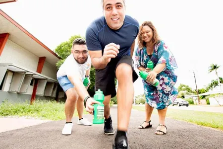 CDU Student Association  Secretary Ali Dhirani and Psychology lecturer Carmen Cubillo help CDU’s Daniel Gahreman (centre) prepare for the fun run