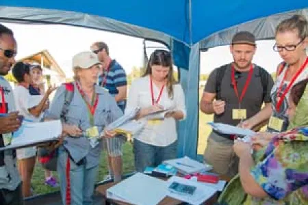 Students barter with a local shop keeper to provide food and water for refugees as part of the scenario