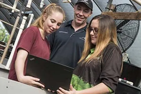 From left: Kayla Weckert, Chad Mumme and Taleeha Ramsay check out the Island Ranger app