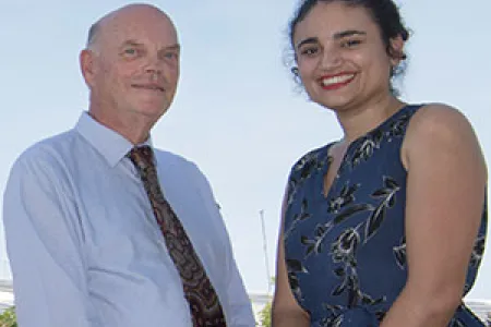 DVC Research and Research Training Professor Lawrence Cram celebrates with Minister for Environment and Natural Resources Ms Lauren Moss