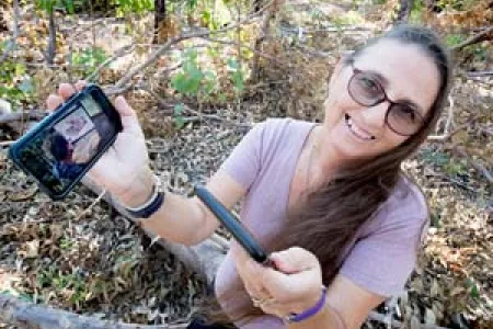 Research fellow Marianne St Clair shows how her smartphone can be used as a diagnostic tool