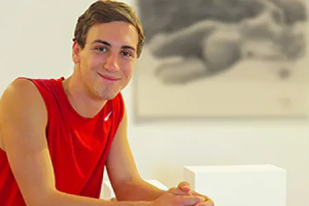 Visual Arts student Matthew Grant with one of the charcoal life drawings selected for exhibition.