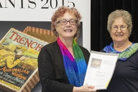 Federal Ministry for the Arts executive director Sally Basser (left) presents the Community Heritage Grant certificate to CDU Nursing Museum curator Janie Mason