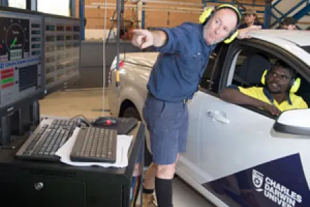 Automotive lecturer Mark James (left) and student Terrence Bismark check engine data from a ute on the new dynamometer, which will be on display at Open Day on Sunday, 20 August. Photo: Julianne Osborne
