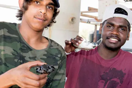 Tennant Creek High School students Josiah Armstrong and Owen Mick experience Aquaculture at CDU Open Day. Photo: Julianne Osborne