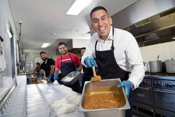 CDU’s International Student Support Project Officer Ben Poveda-Alfonso helps prepare meals for the Kindness Shake.