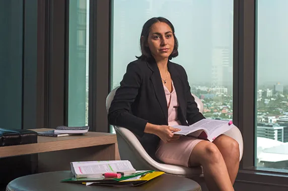 Beth at her law office with book