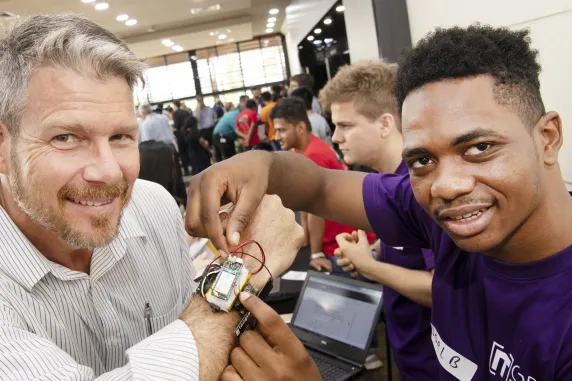 Student shows of robot strapped to the wrist of an onlooker