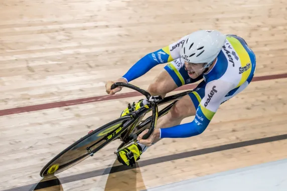 CDU student Jacob Schmid cycling on an indoor track