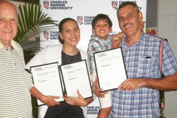 Rikki Bruce holding her three awards