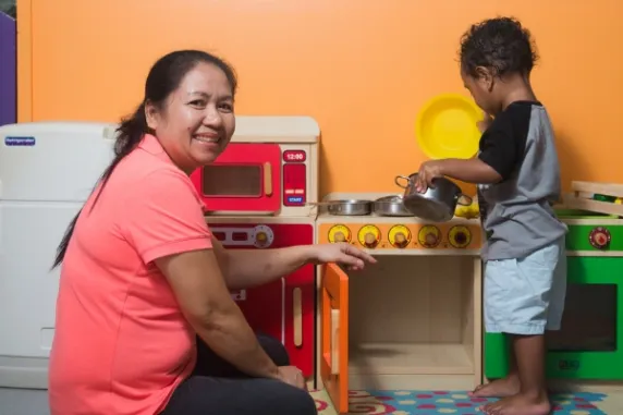 Woman with child smiling at the camera