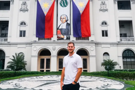 Joel standing in front of De la Salle University