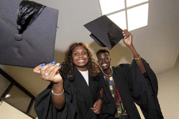 Students Nancy Holtze and Makuer Akol celebrate graduating from the Team Aspire program