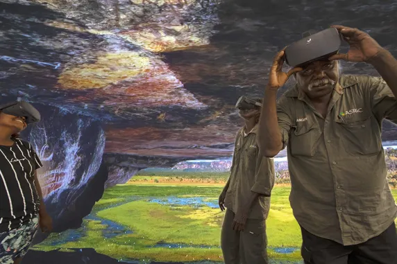 Arafura Swamp Rangers Aboriginal Corporation members Erica Ngurruwuthun, David Bidingal and Charlie Ramandjarri test out the virtual reality technology at CDU.  Virtual reality image courtesy of Injalak Arts. 