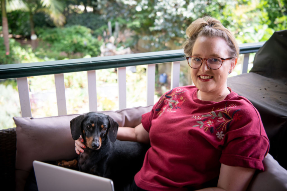 CDU student Claire Bowditch with laptop and her puppy