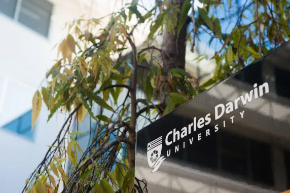 Charles Darwin University sign surrounded by leaves