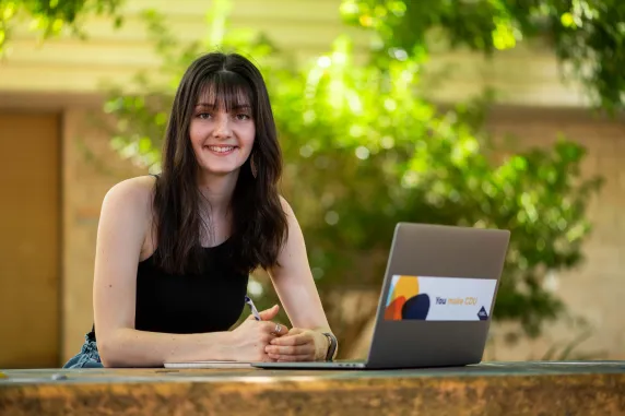 Nursing student on campus with laptop