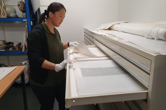 Eileen Lim, Exhibitions and Collections Officer, stores works on paper at the CDU Art  Collection storeroom. 