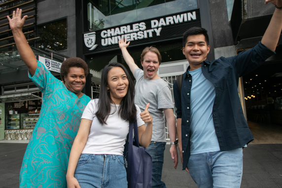 four students posing in front of CDU Sydney campus