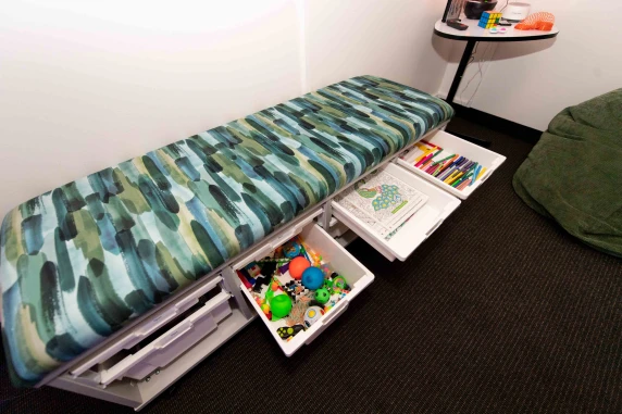 bench with paper pens and toys