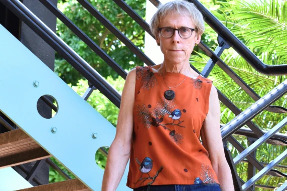 Professor Kim Humphery standing on a Northern Institute staircase
