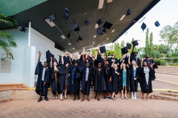Aspire students throwing graduation caps