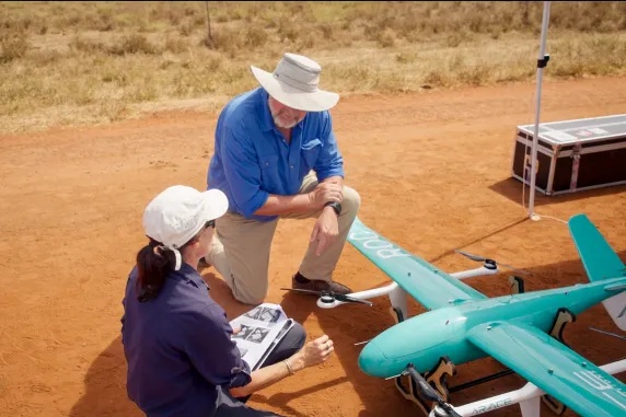 two people with drone