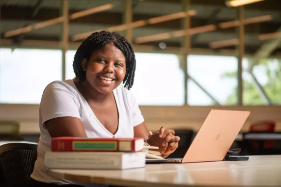 Student with laptop and books