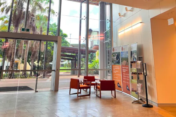 foyer of Menzies Building Red 9 at Campus - large internal building with glass windows and orange chairs