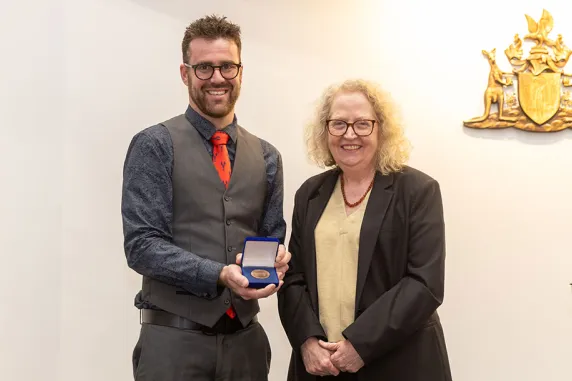 Jon receives his Supreme Court Medal from Justice Meredith Day Huntingford
