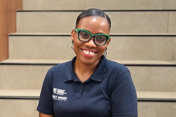 smiling isabella with green glasses sitting in danala campus