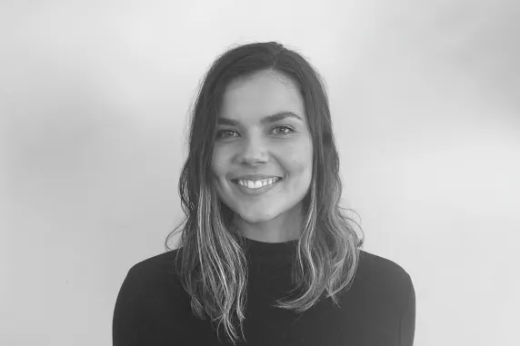 young woman in turtle neck and long straight hair smiling