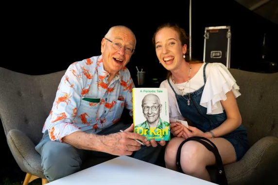 Dr Karl with a woman showing off Dr Karls book
