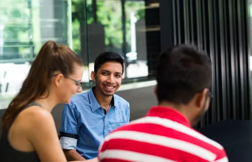 Three students talking in a group