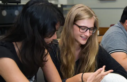 Two students reading a book