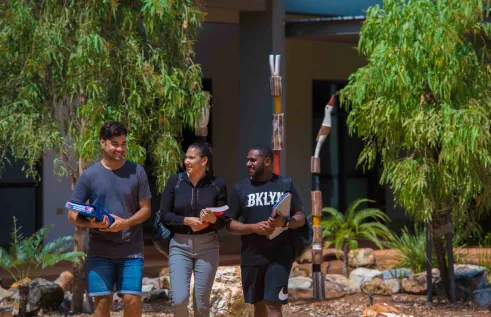 First nations students walking in front of acike building 