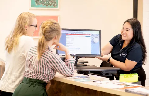 Staff member helping students