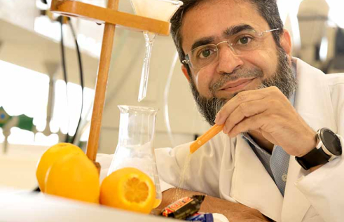 College of Health and Human Sciences Assistant Dean Dr Sufyan Akram in a laboratory pictured with oranges and chocolates.