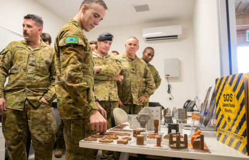 Caption: Australian Army soldiers check out the parts created using 3D printing technology.