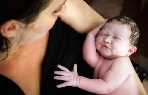 Woman with infant in hand