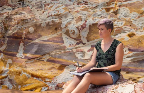 CDU Arts student studying outdoors