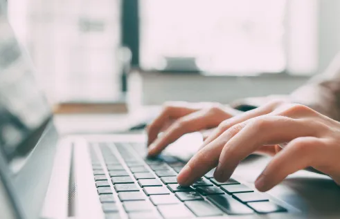 Person typing on a computer